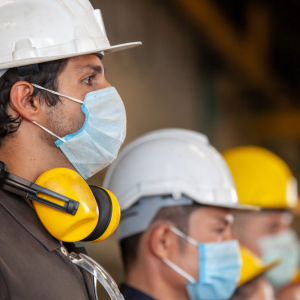 Industrial workers wearing protective face masks