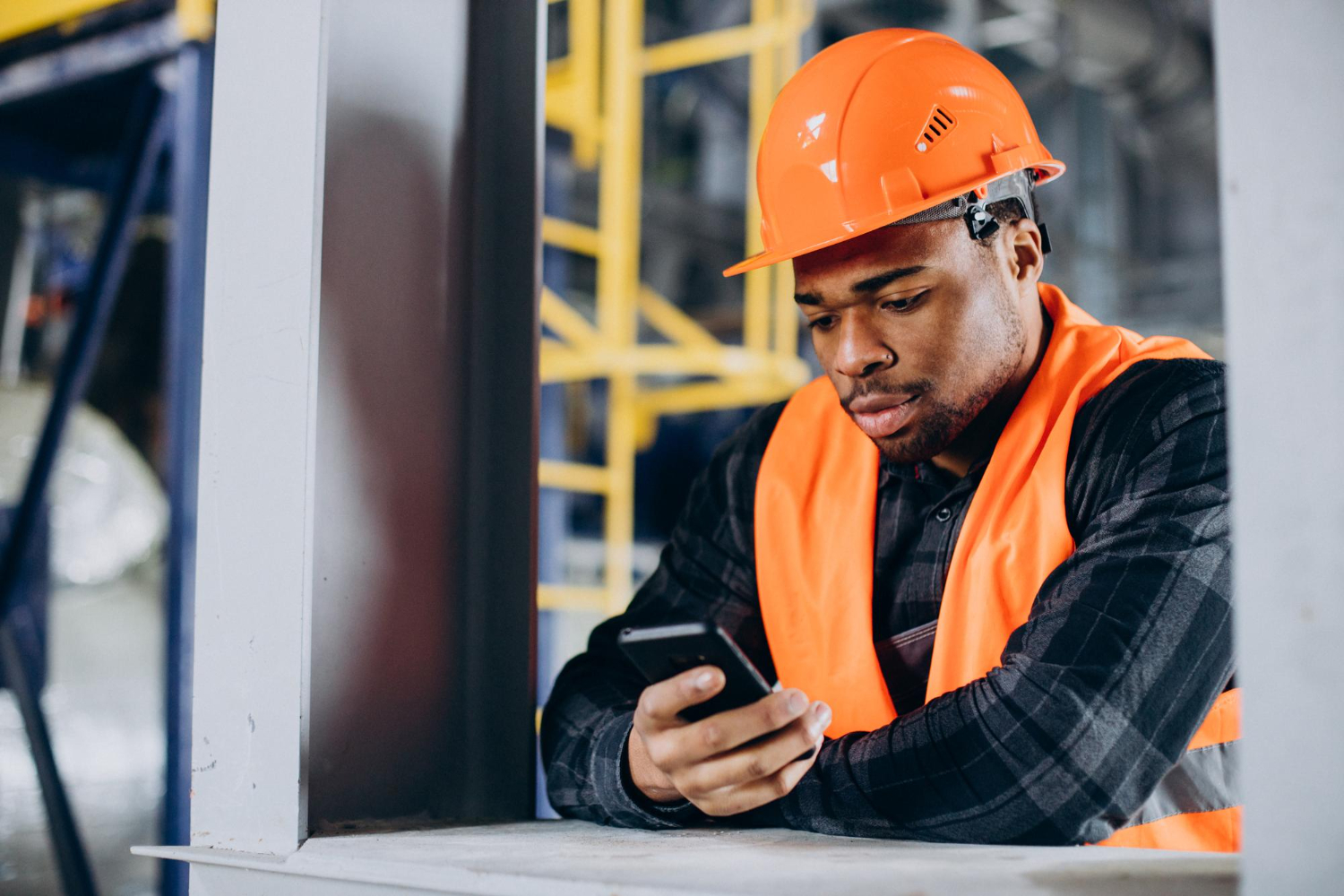 Worker looking at his hand-held device